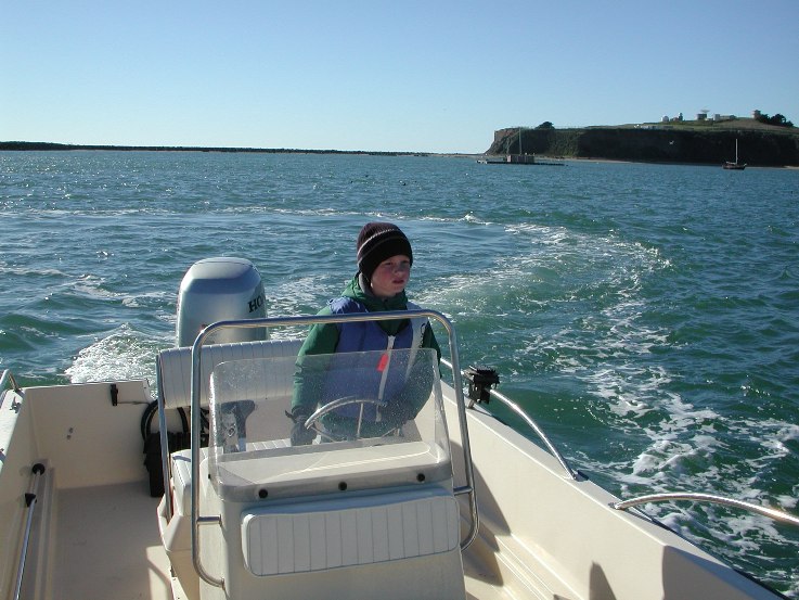 John learning to "pilot" on our 1st boat. Note the concentration...