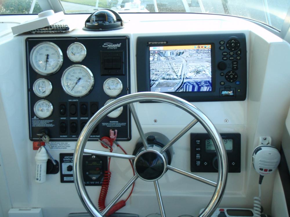 Furuno electronics, with a custom console.  Below that is a Simrad auto pilot.