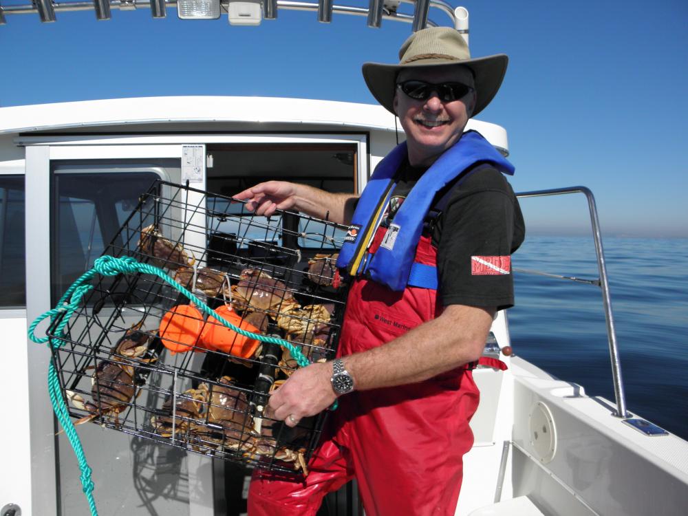 Robert on Sanity Check with a just pulled crab pot.  Check out 'Lake Pacific' in the background.